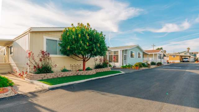 A mobile home park with well-kept gardens.