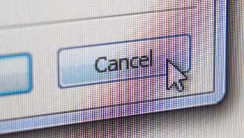 A close-up of a computer screen displaying a "Cancel" button with a cursor pointing at it.