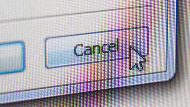 A close-up of a computer screen displaying a "Cancel" button with a cursor pointing at it.
