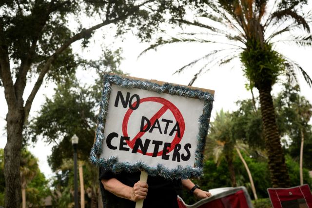 A protestor holding a "no data centers" sign.