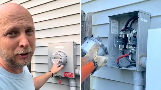 A person interacts with an electric meter on a house while another holds a detached part of the meter in their gloved hand.