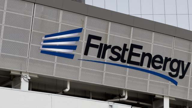 A close-up of the FirstEnergy logo on a textured building facade.