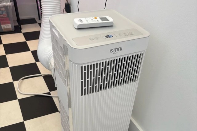 An Omni AC unit on a black and white tiled floor.