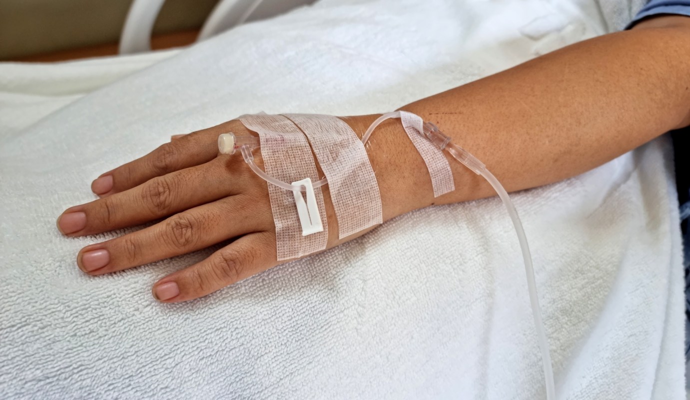 A person's hand with an IV.