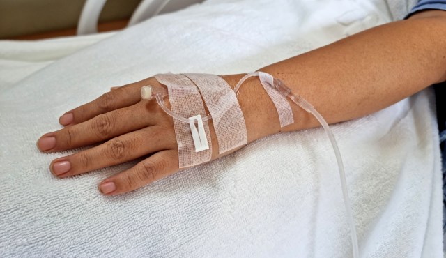 A person's hand with an IV.