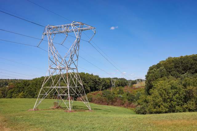 Transmission towers in a rolling field.