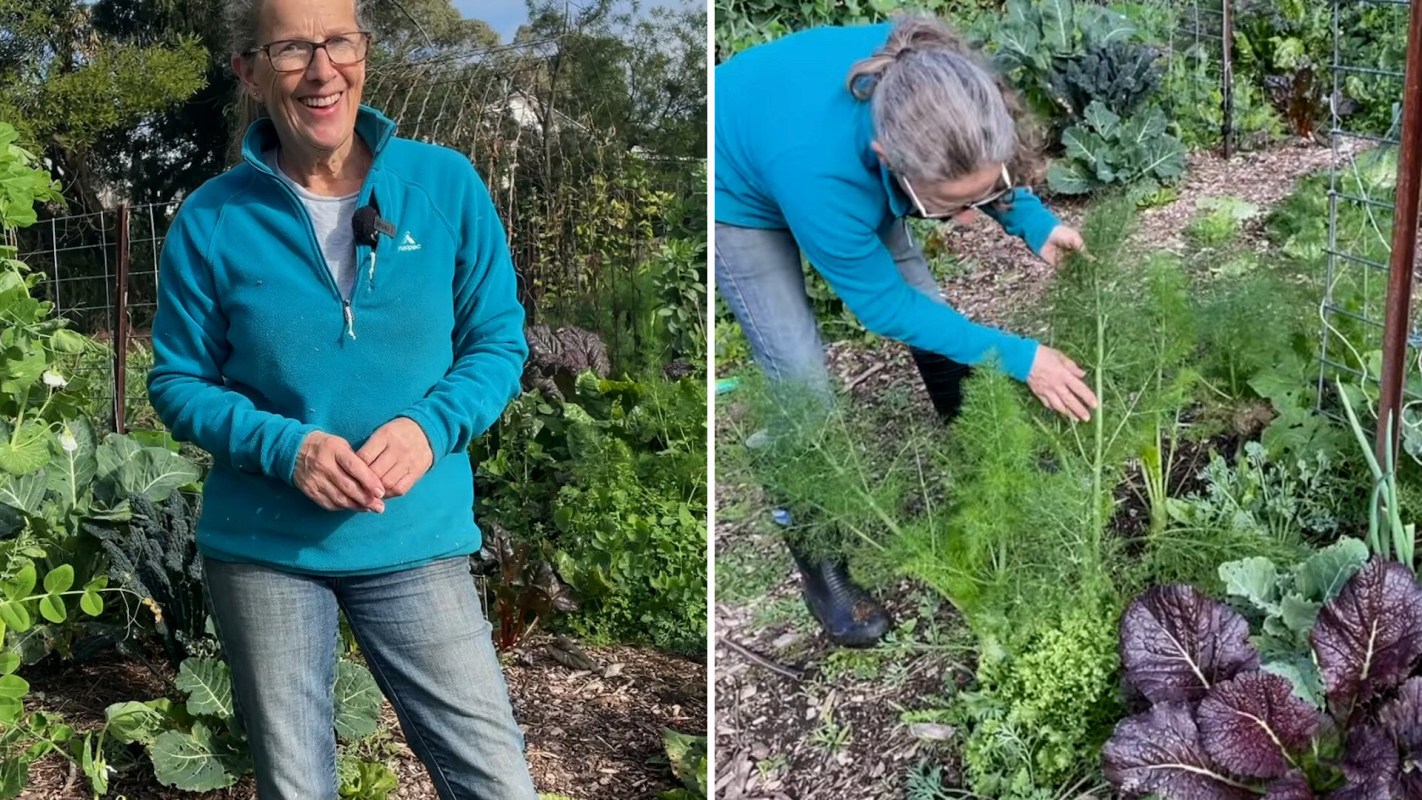 A woman showcasing her vegetable garden.