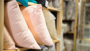 Pillows on a shelf at a home decor store.