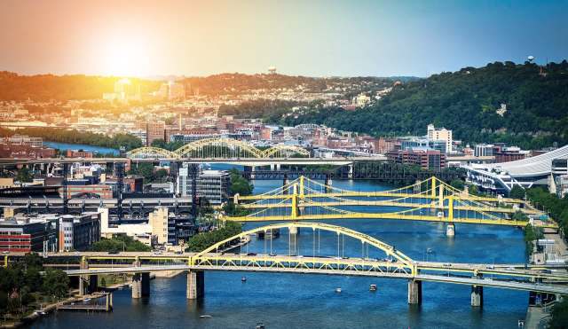 The Pittsburgh skyline featuring city's iconic yellow suspension bridges.