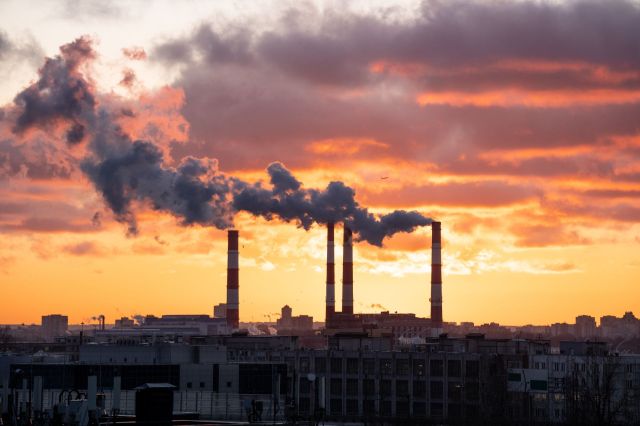 Smoke rises from industrial chimneys.