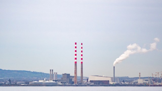 An industrial facility with tall smokestacks.