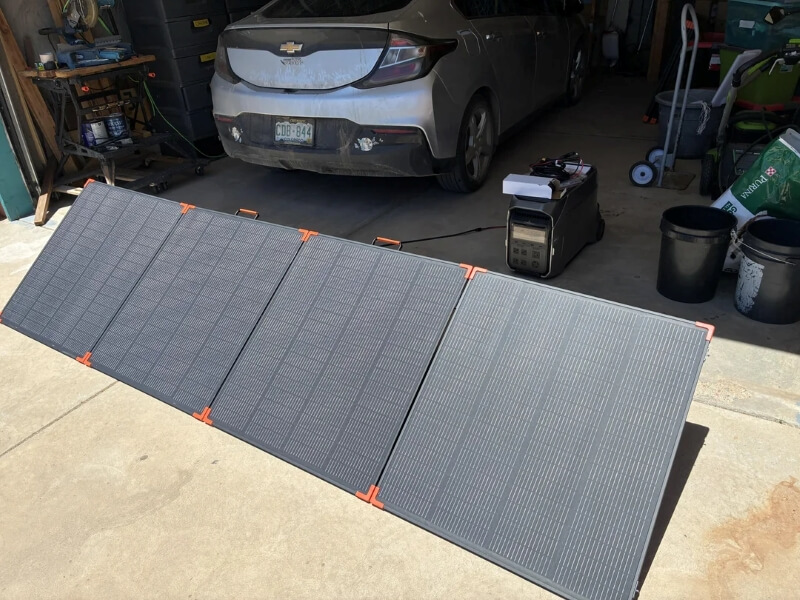 Portable solar panels in front of a garage.