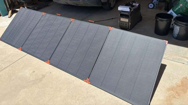 Portable solar panels in front of a garage.