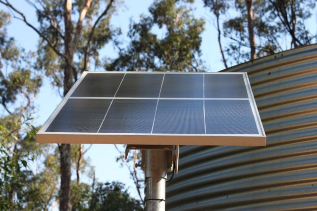 A solar panel mounted on a pole.