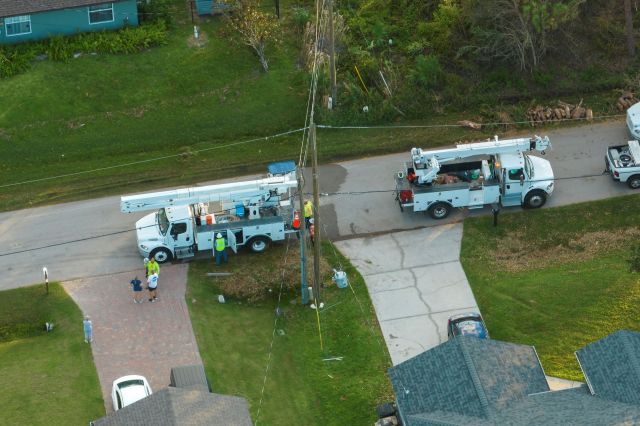 Workers for an electric company working on power lines.