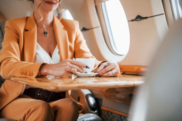 A woman sitting in a private jet.
