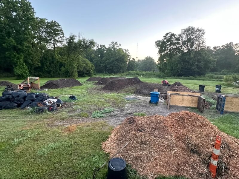 A composting area with mounds of manure and organic waste.