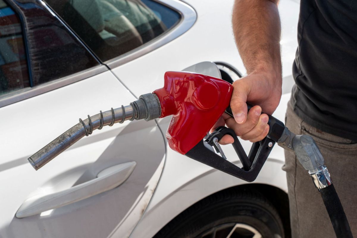 A man pumping gas.