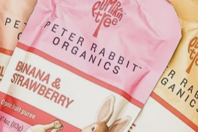 Three packages of Peter Rabbit Organics fruit puree, featuring flavors banana & strawberry, with a cute rabbit illustration.