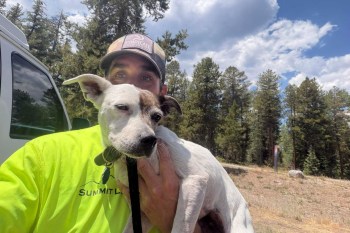 A rescue worker holding Brinley.