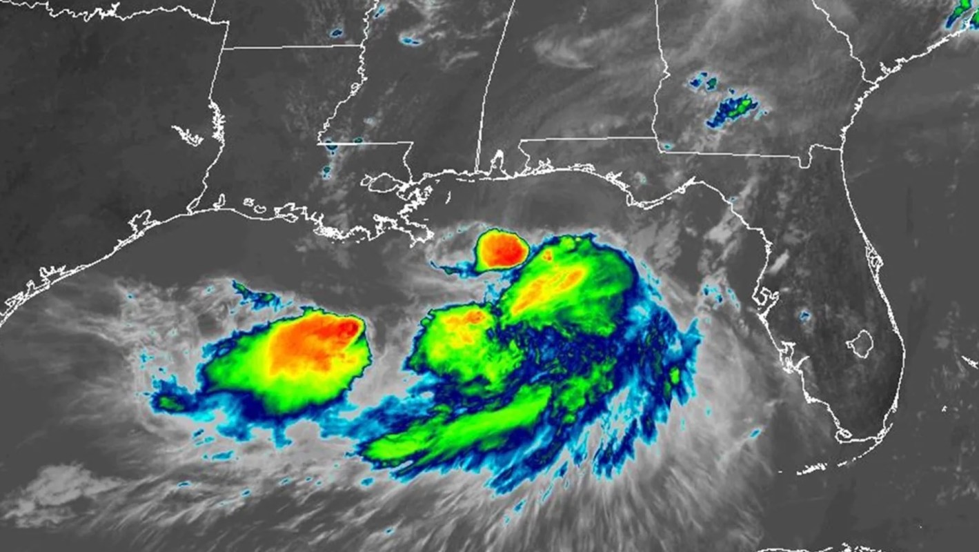 A satellite image showing a developing storm system over the Gulf of Mexico with vibrant cloud formations.