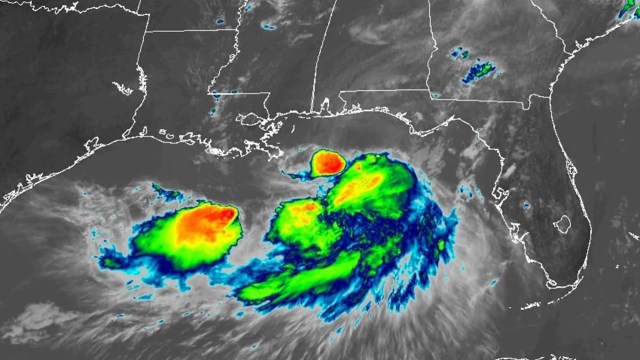 A satellite image showing a developing storm system over the Gulf of Mexico with vibrant cloud formations.