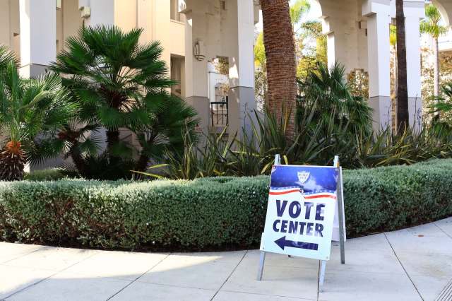 A sign directing people to a vote center.