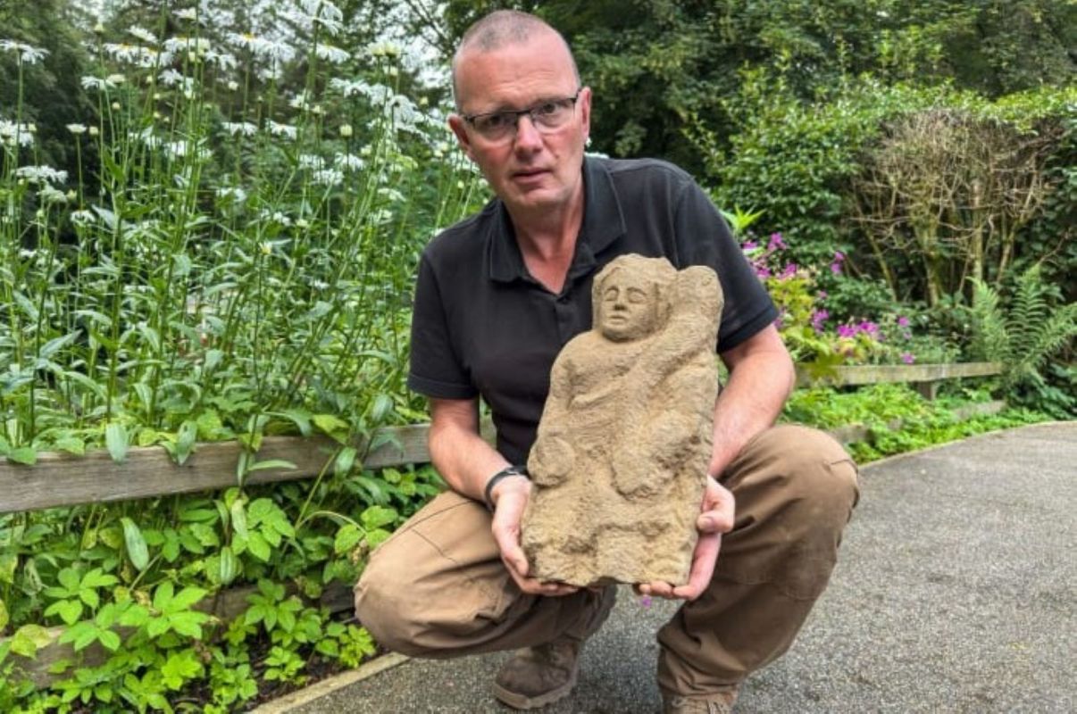Archaeologist Andrew Birley with a Roman genius figure.