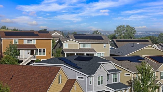 Houses with solar panels in a suburban neighborhood.