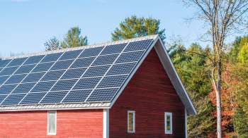 A red barn with a solar roof.