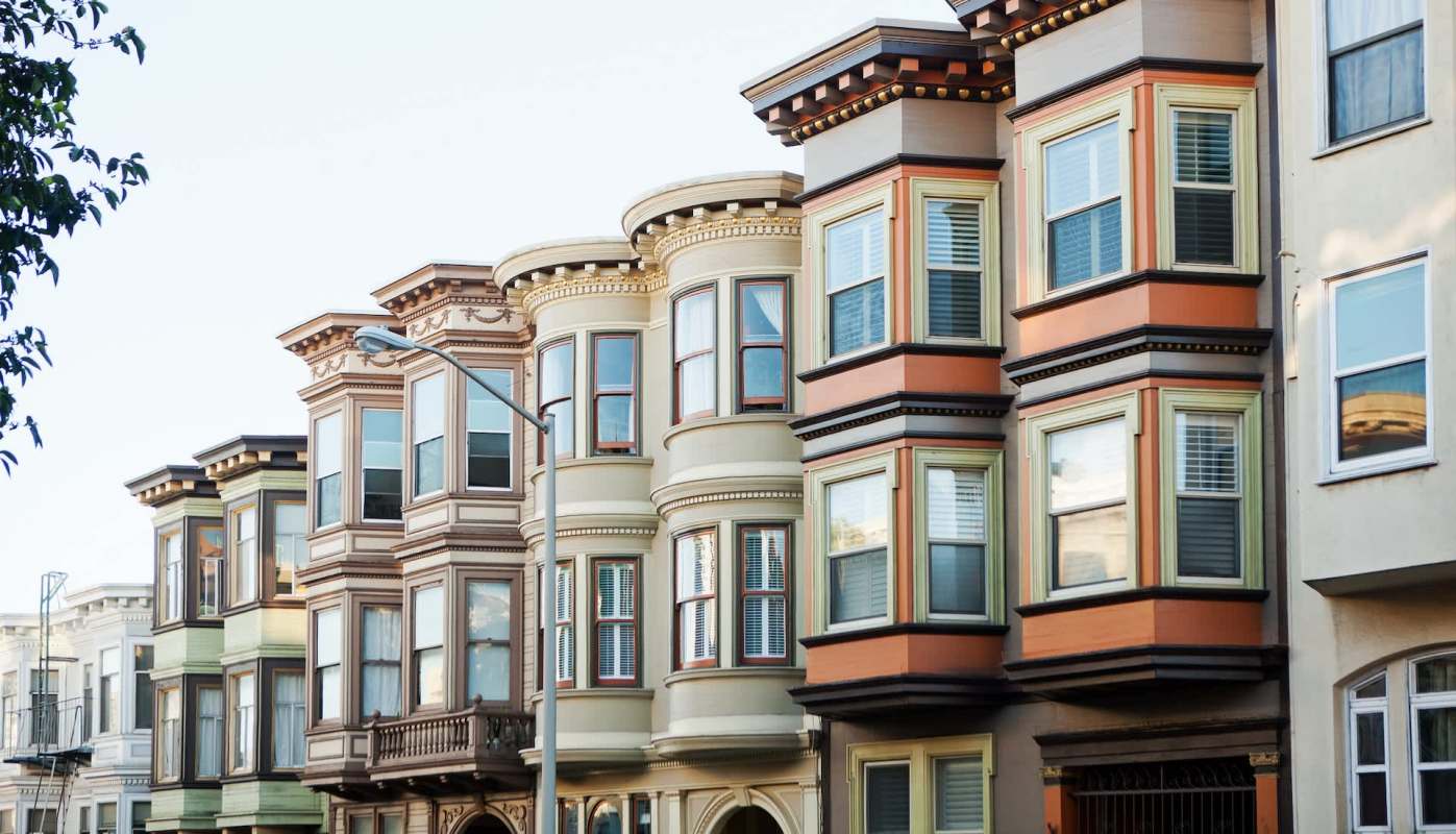 A row of Victorian-style houses with bay windows.