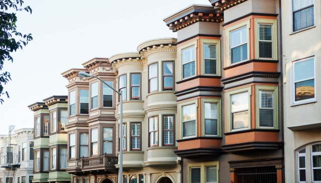 A row of Victorian-style houses with bay windows.