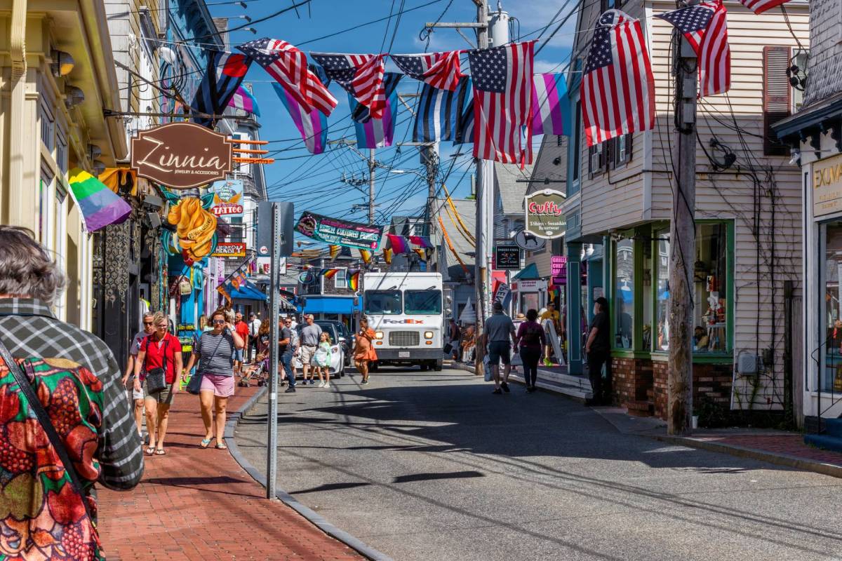 A commercial street in Provincetown decorated with American flags.