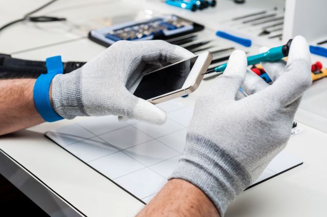 A technician repairing a smartphone.