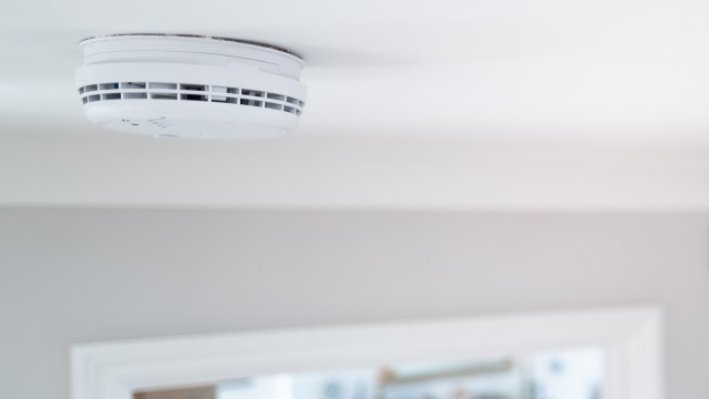 A smoke detector on a ceiling.