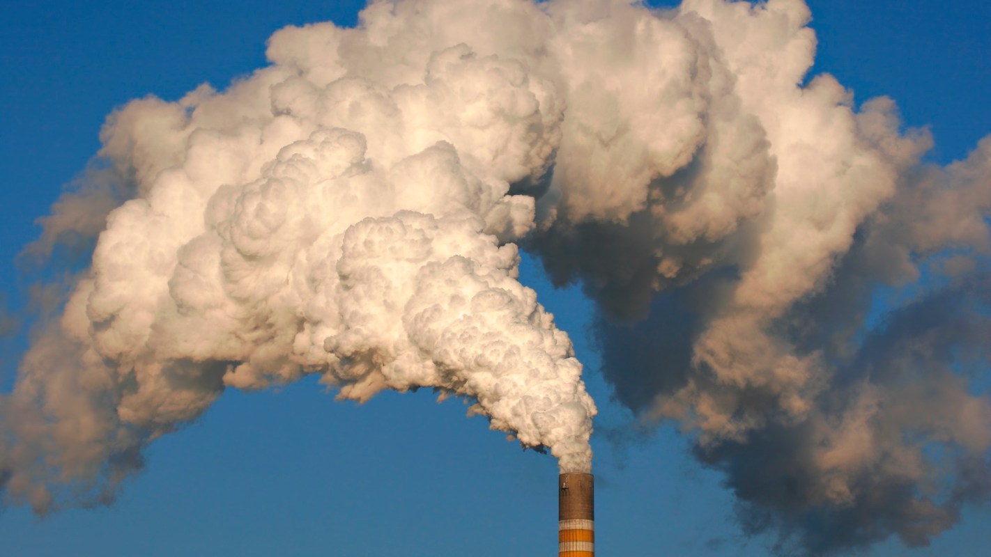 Smoke coming out of a smokestack.
