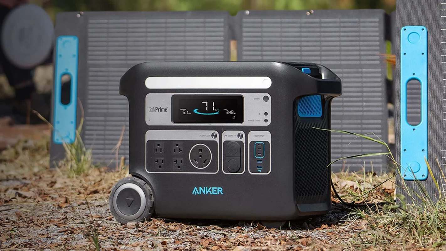 A portable power station with outlets and a solar panel in a natural outdoor setting.