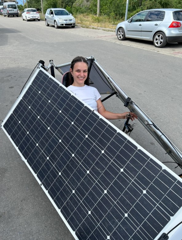 A woman smiling while operating the Solar Bear.