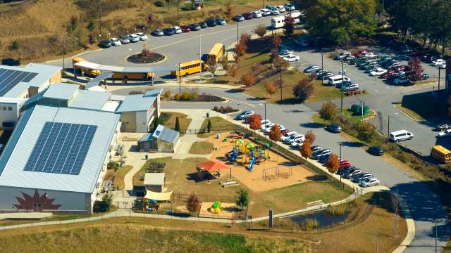 An aerial view of a school with solar panels.
