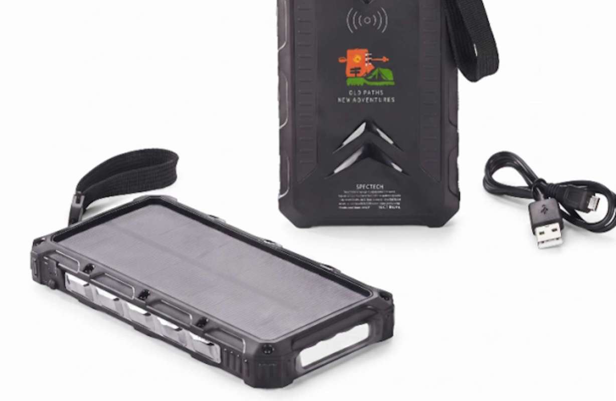A portable solar charger with a USB cable and a strap for carrying.