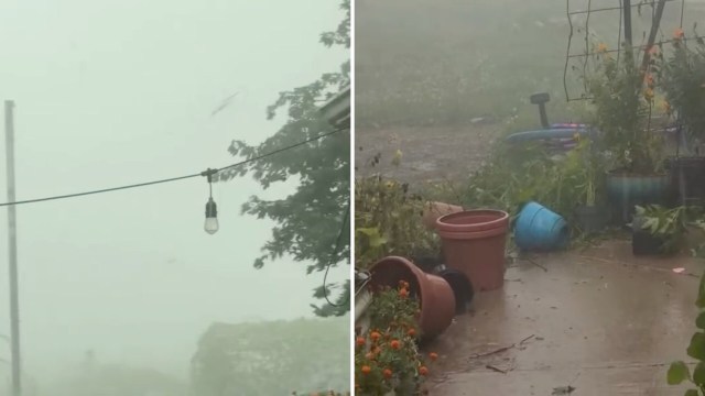 A foggy scene showing overturned flower pots and debris during heavy rain and strong winds.