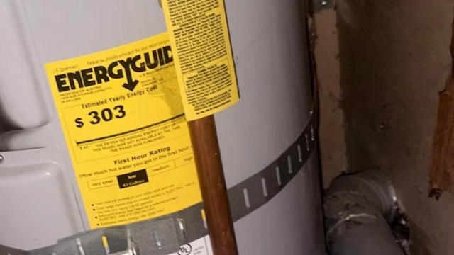 A water heater with an EnergyGuide label showing estimated yearly energy cost and specifications.
