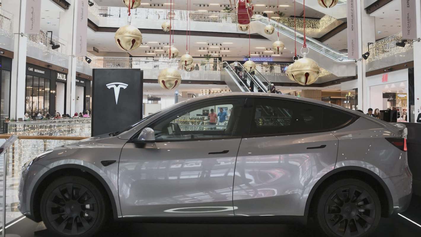 A silver Tesla Model Y displayed in a mall.