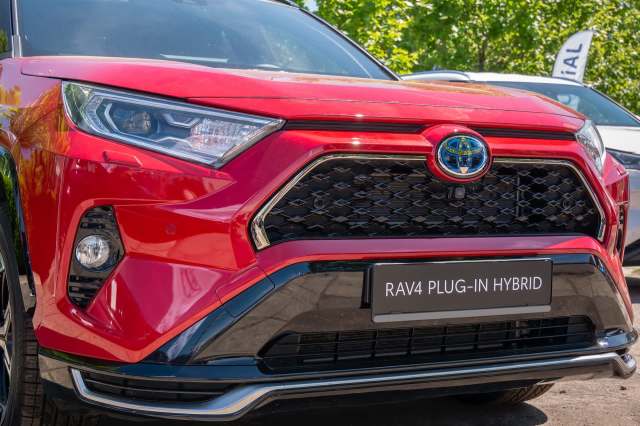 A red Toyota RAV4 Plug-In Hybrid.