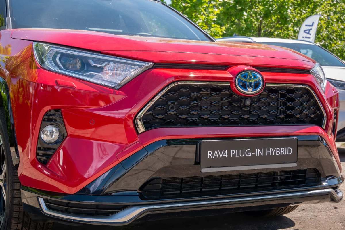A red Toyota RAV4 plug-in hybrid.