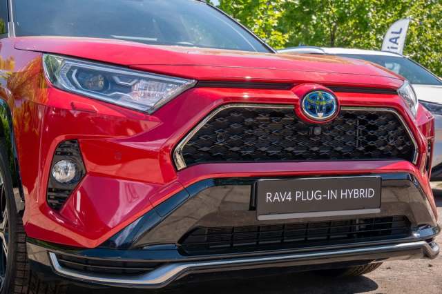 A red Toyota RAV4 plug-in hybrid.