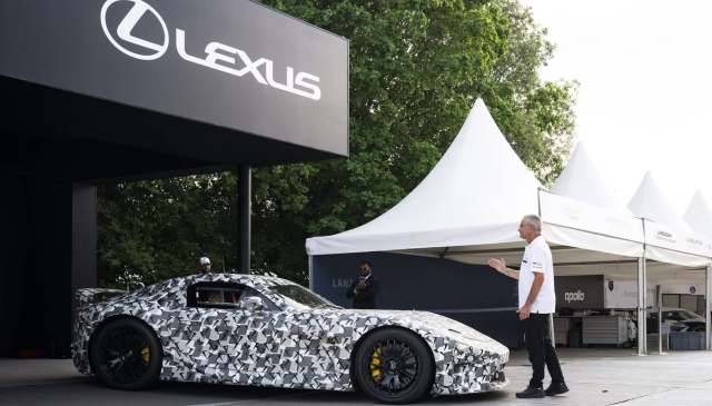 An electric LFA hypercar under a Lexus sign.