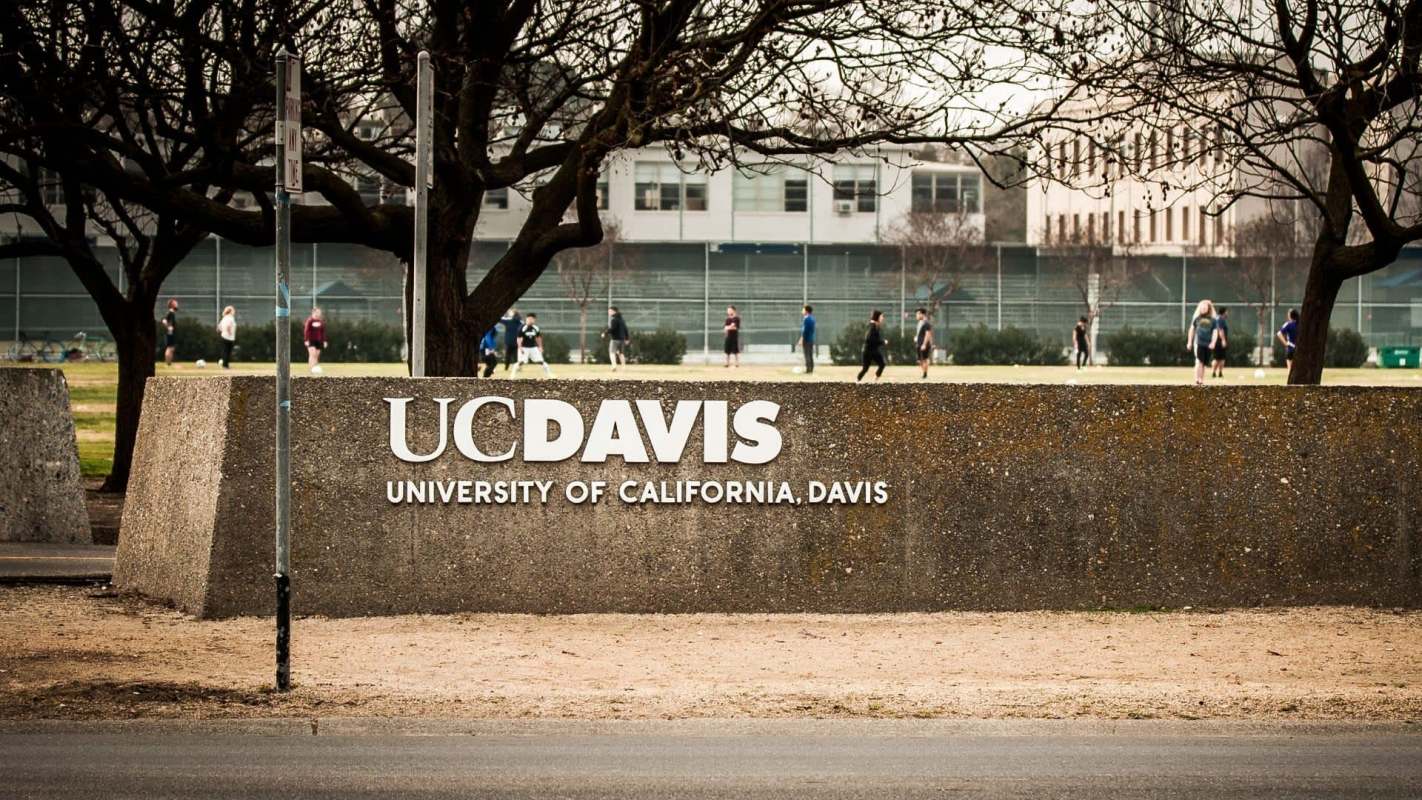 A large sign displaying "UC Davis, University of California, Davis."