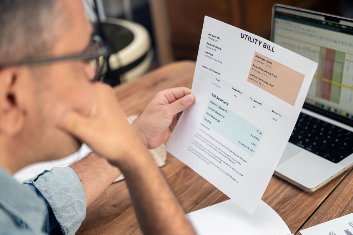 A man looking at a utility bill.