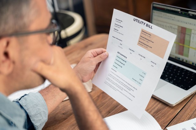 A man looking at a utility bill.